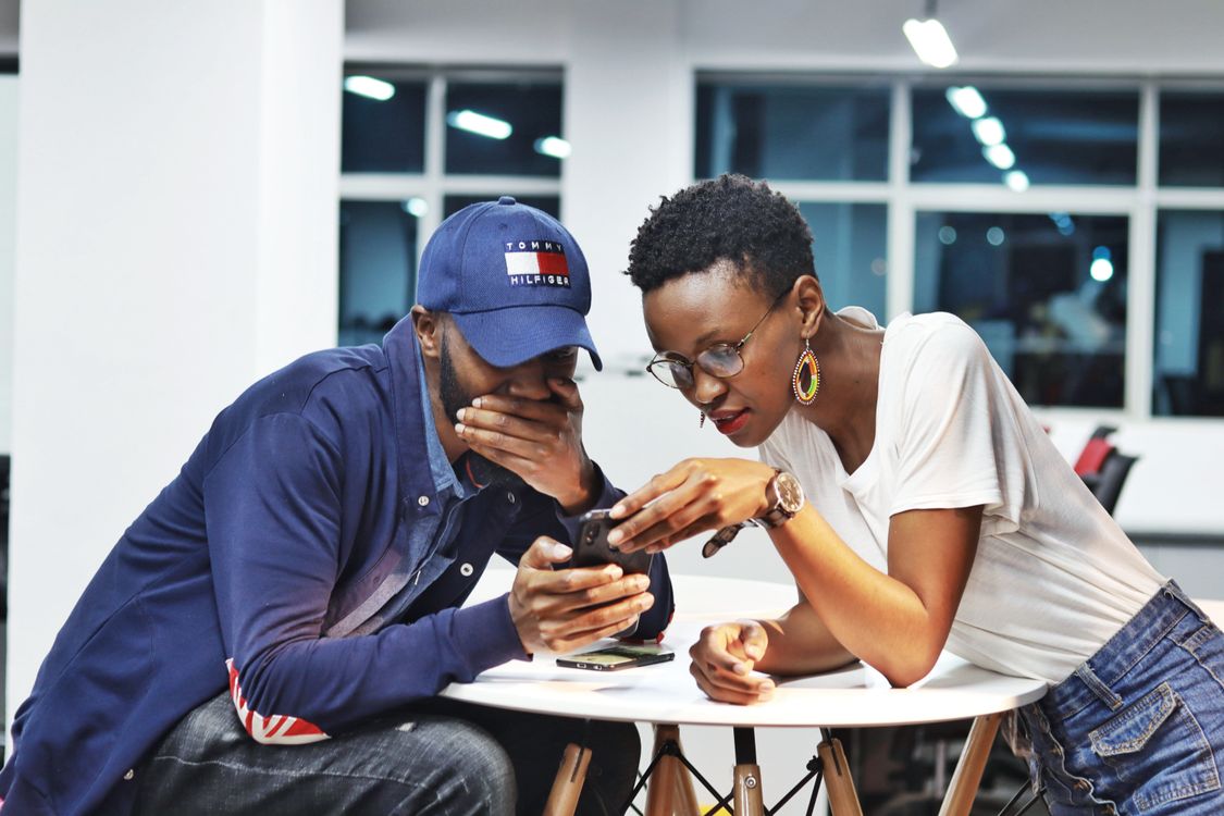 Two people looking at a smartphone together